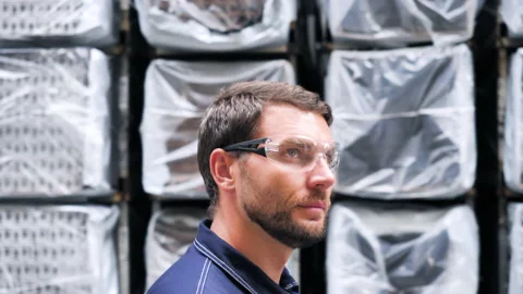 Logistics Engineer Warehouse Worker Walking Past Shelves Full Industrial Goods. 動画素材 146542044