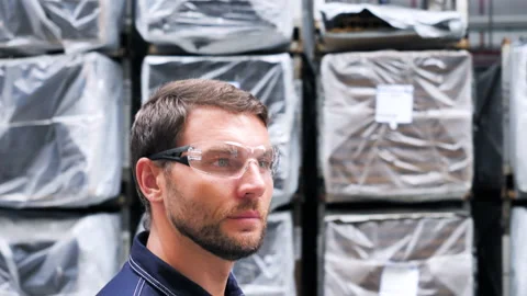 Logistics Engineer Warehouse Worker Walking Past Shelves Full Industrial Goods. 스톡 동영상 146542328