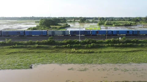 Logistics freight train hauling cargo containers through flood. Stock Footage 341232595