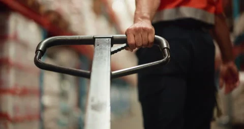 Logistics, loader and hands with pallet truck, warehouse and restock for goods Video stock 326094864