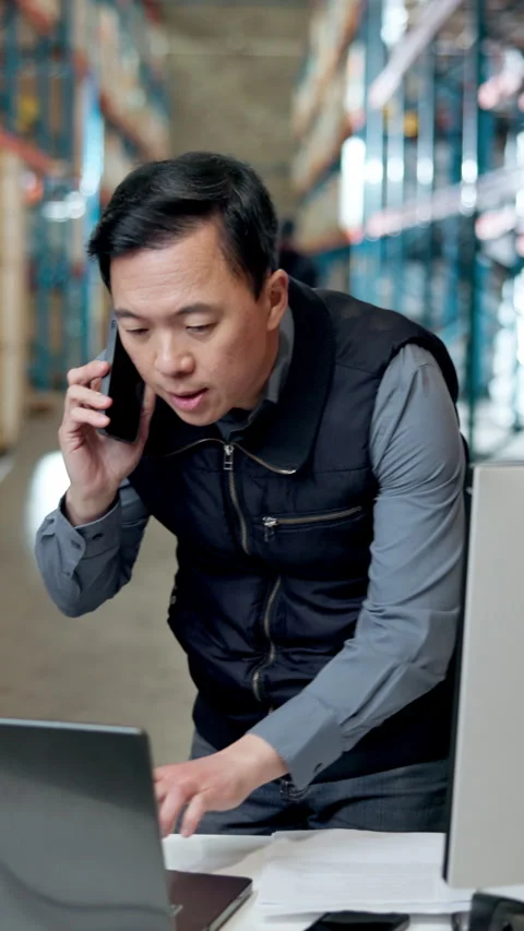 Logistics, man and phone call in warehouse with laptop, order confirmation and Stock Footage 340541032