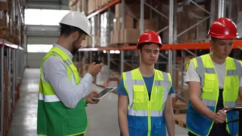 Logistics manager using walkie-talkie in warehouse Stock Footage 161948917