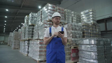 Logistics manager worker wearing blue overalls uniform at the industrial factory Stock Footage 202592759