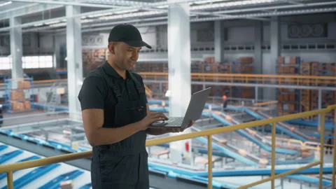 Logistics Packages Sorting Warehouse Worker using Laptop Stock Footage 251706150