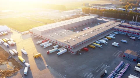 Logistics park with a warehouse - loading hub. Semi-trucks with cargo trailers Stock Footage 143021334