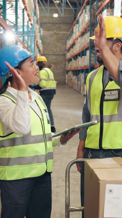 Logistics, people and high five with tablet in warehouse for supply chain or Stock Footage 340540538
