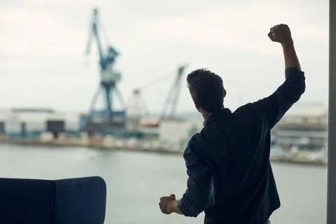 Logistics port, engineer and man with fist pump, window and celebration for.. Stock Photos