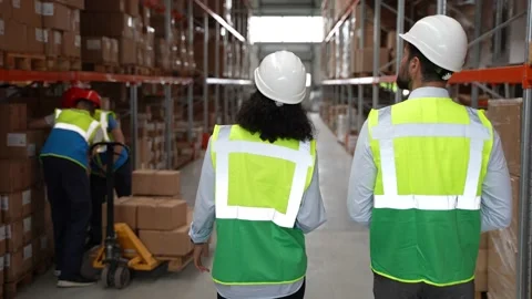 Logistics specialists walking through storehouse Stock Footage 161954201