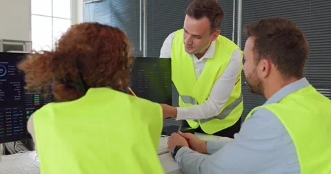 Logistics team analyzing transport dashboards in office control center Stock Footage 345729121