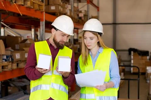 Logistics Team Comparing Product Samples Against Specification Documents 스톡 사진
