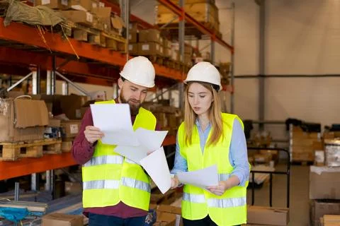 Logistics Team Comparing Shipping Documents for Compliance Verification 스톡 사진
