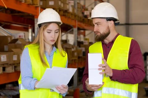Logistics Team Confirming Product Specifications Against Documentation Stock Photos