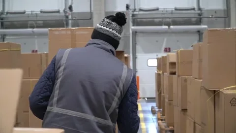 Logistics team unloads delivery, lines up boxes, inspects and manages inventory Vídeo Stock 242700760