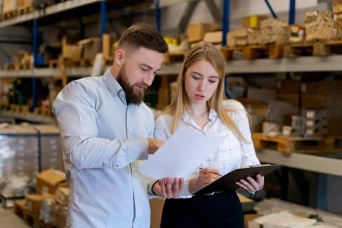 Logistics Team Verifying Shipping Documents and Inventory List in Warehouse Stock Photos