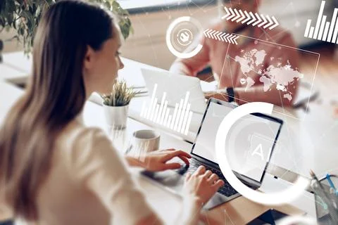 Logistics team working on laptops in a modern office during business hours Stock Photos
