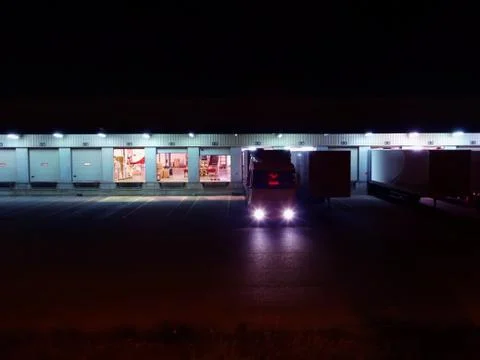 Logistics transport platform loading night truck at loading docks Stock Photos