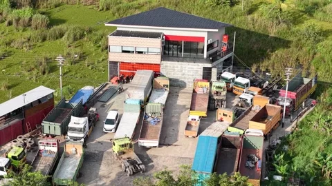 The logistics transport services office has many trucks parked in front of .. Video stock 336473574