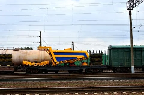 Logistics transportation heavy mining dump truck by rail. Yellow mining truck Foto stock