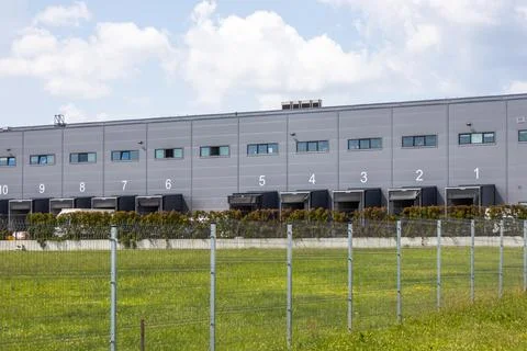 Logistics warehouse building with numbered cargo gates Stock Photos