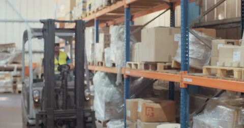 Logistics worker getting off a forklift and marking items Stock Footage 65040750