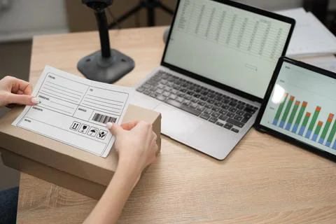 Logistics worker labeling parcel package for shipment service Stock Photos