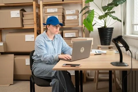 Logistics Worker Using Laptop In Parcel Warehouse Stock Photos