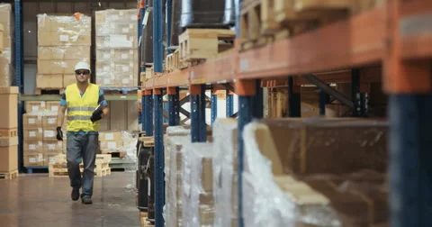Logistics worker walking in a warehouse in slow motion Stock Footage 65040084