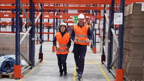 Logistics workers running through warehouse Stock Footage 312856429
