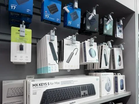 Logitech computer accessories and Samsung storage drives displayed on retail Stock Photos