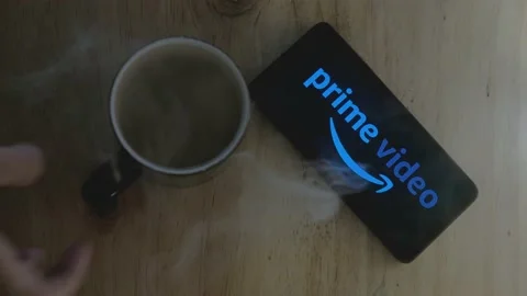 Logo of Amazon Prime Video on Android smartphone hot cup Stock Footage 157218354