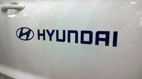 Logo and text name of car Hyundai on white door of vehicle. Inscription. Auto Stock Photos