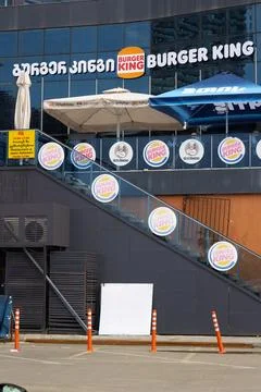 Logo of chain Burger King, Usta Donerci on stairs of fastfood restaurant Stock Photos