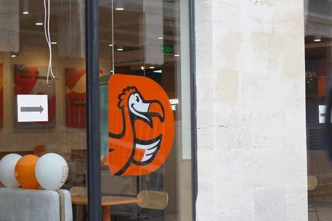 Logo of Dodo pizza on orange shape with bird on window of fast food cafe Stock Photos