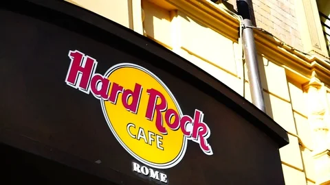 Logo on the external façade of Rome's hard rock cafe. thematic restaurant Stock Footage 117069998