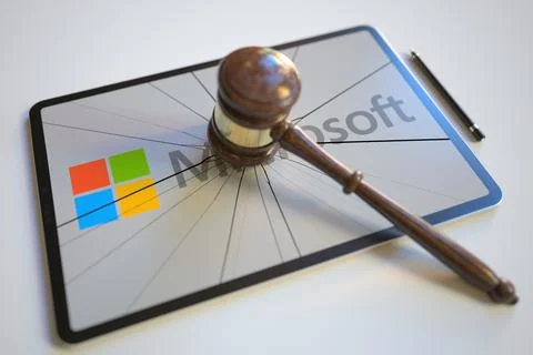 Logo of MICROSOFT on the tablet computer screen hit by judge's gavel. Court Illustrazione stock