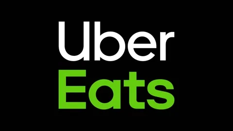 Logo of Uber Eats food delivery, push in on black background - graphic Stock Footage 148357366