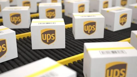 Logo of UPS on the white boxes on the conveyor. Editorial 3D rendering Illustrazione stock