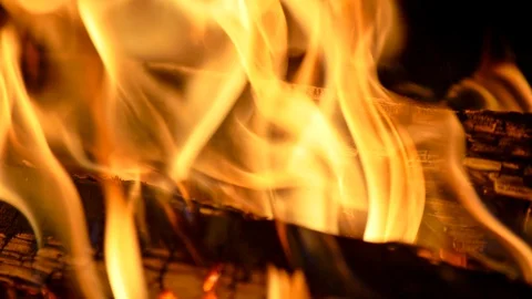 Logs burning in a bonfire. Yellow flames at night. Slow motion close-up shot Stock-Footage 129422722