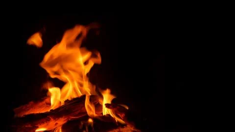 Logs burning fire on black background Stock Photos