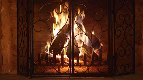 Logs Burning in Vintage Stone Fireplace with Decorative Screen and Grate 库存影片 80832549