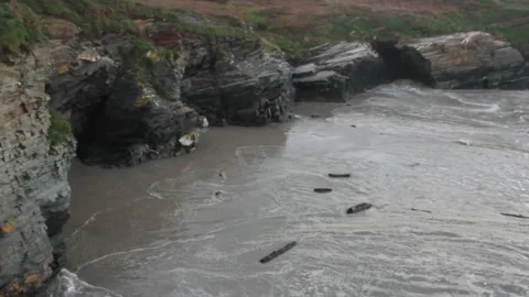 Logs moved by the waves in a beach in the north of Spain Stock Footage 303671062