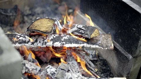 Logs of wood burning in a fire pit, shot in 24 FPS Stock Footage 179023491