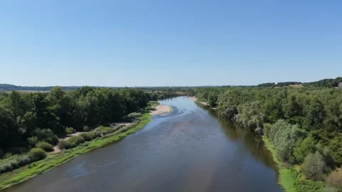 The Loire River winding through lush green forests and natural riverbanks near Stock Footage 346711799