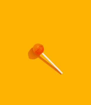 Lollipop on orange background Stock Photos
