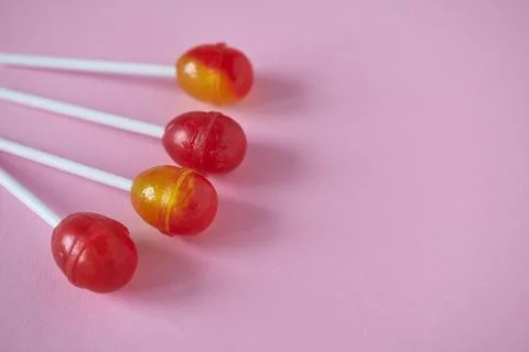 Lollipops on a pink background with space for text. Selective focus. Stock Photos