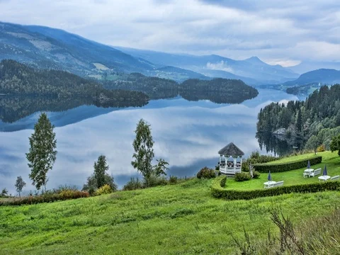 Lomen Norway beautiful reflections on setting at resort on water called Marit 스톡 동영상 75688064