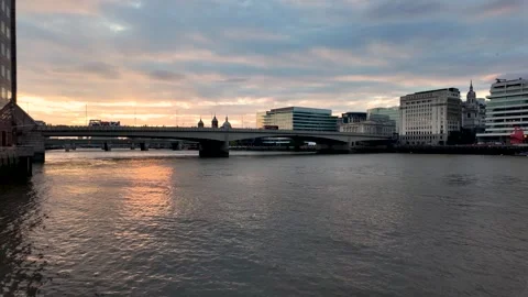London Bridge spans the River Thames at golden hour as gentle ripples move in Stock Footage 342186146