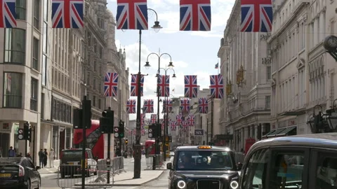 London, British Union Jack flags hanging above Strand St 動画素材 217433780