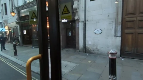 London bus double decker getting in door closing driving on London city street Stock Footage 103856790