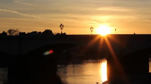 London Bus passes through setting sun on bridge Video stock 22485161